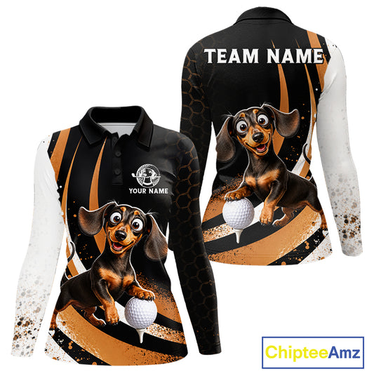 Front and back views of a long-sleeve polo shirt featuring a cartoon dachshund golf dog graphic on a black, orange, and white splatter design. The front shows a polo collar, 'YOUR NAME' placeholder text, and a golf ball graphic.