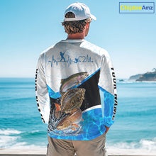 Load image into Gallery viewer, Person wearing a fishing-themed long-sleeve shirt with a scenic ocean background
