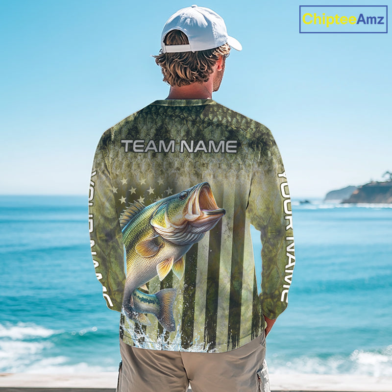 Person wearing a fishing-themed shirt with a large mouth bass graphic and 'Team Name' text, standing by the ocean.