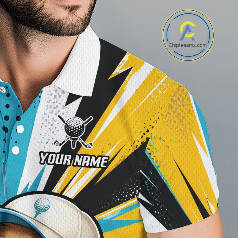 A close-up of a man wearing a short-sleeve polo shirt with a bold yellow, black, white, and turquoise abstract graphic design. The shirt features a white collar, a customizable golf ball graphic with the text 'YOUR NAME', and a teal button placket.