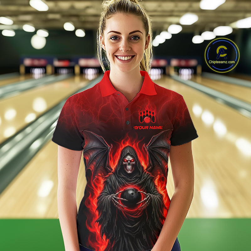A woman wearing a custom short-sleeve bowling polo shirt with a red and black flame-themed grim reaper graphic, standing in a bowling alley. The shirt features a red collar, a red and black gradient body, and a graphic of a hooded reaper holding a bowling ball with flames