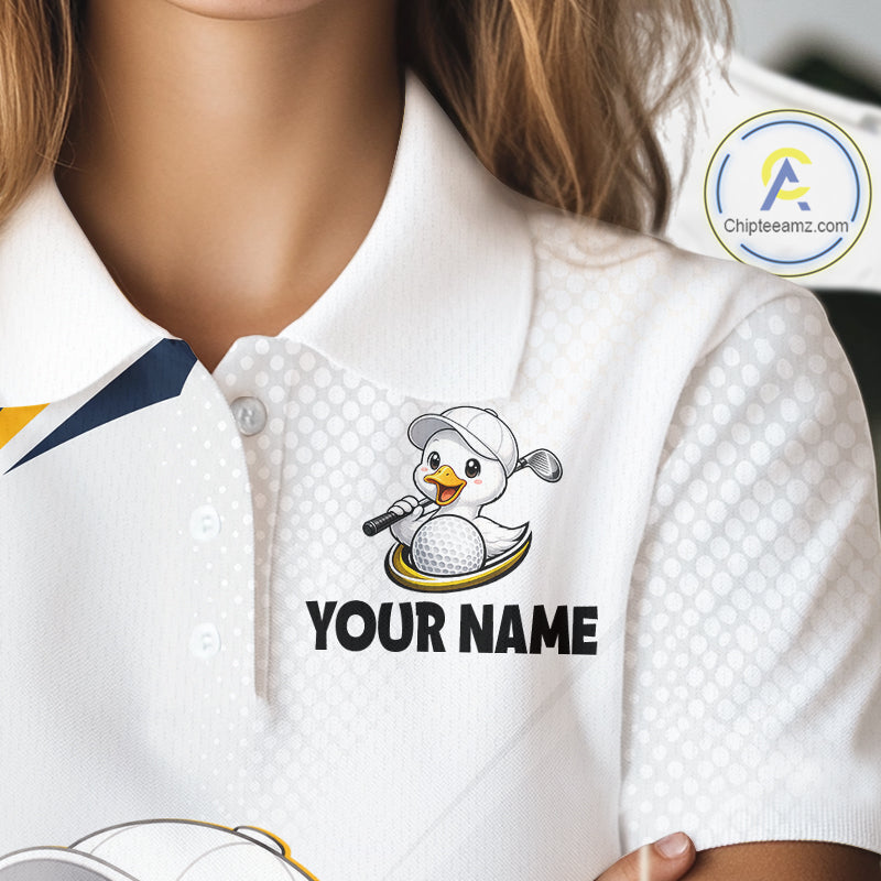 A close-up of a white polo shirt worn by a person, featuring a custom graphic of a cartoon duck wearing a golf hat and holding a golf club, above the text 'YOUR NAME'.