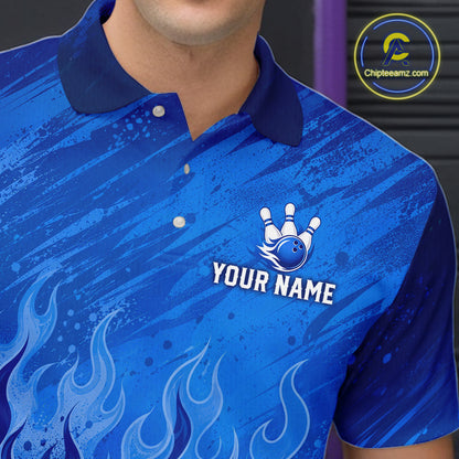 A close-up of a person wearing a blue short-sleeve polo shirt with a dark blue collar, white buttons, flame graphics near the bottom, and a custom bowling-themed chest print featuring a crown bowling pin graphic and the text 'YOUR NAME'.