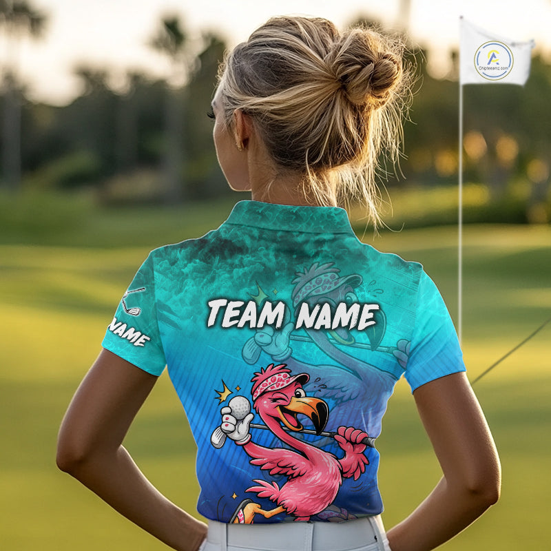 A woman on a golf course seen from behind, wearing a short-sleeve collared golf shirt with a colorful flamingo graphic and the text 'TEAM NAME' on the back. The shirt has a blue and teal gradient design with a pink flamingo illustration.