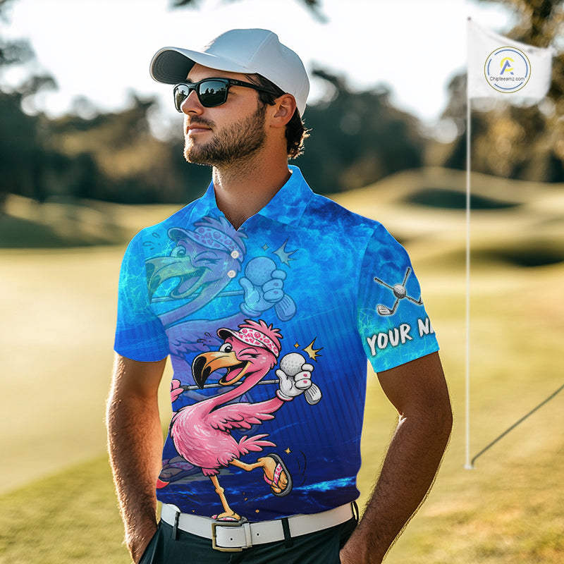 A man wearing a blue custom-printed golf shirt with a cartoon flamingo, sunglasses, and a white cap, standing on a golf course.