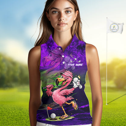 A sleeveless collared women's polo shirt with a vibrant purple and black background featuring a cartoon flamingo golf player, a golf flag, and the text 'YOUR NAME'. The shirt is modeled by a woman standing on a blurred golf course background.
