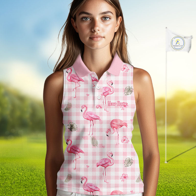 A woman modeling a sleeveless pink gingham polo shirt with a flamingo print, set against a blurred golf course background with a flagstick visible.