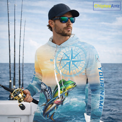 Angler wearing mahi mahi wahoo tuna blue hooded performance fishing shirt on boat with custom name on sleeves