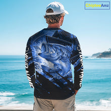 Load image into Gallery viewer, Person wearing a long sleeve fishing shirt with a blue largemouth bass fish design, standing by the ocean.