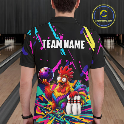 Person wearing a black bowling shirt with colorful design and  chicken graphic in a bowling alley.