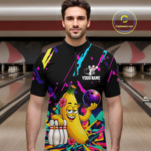 Load image into Gallery viewer, Man wearing a colorful bowling shirt with a cartoon banana character in a bowling alley.