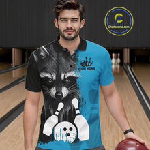 Load image into Gallery viewer, Man wearing a black and blue raccoon bowling polo shirt at a bowling alley front view.