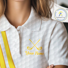 Load image into Gallery viewer, White polo shirt with yellow stripes and embroidered golf clubs and text on a blurred background