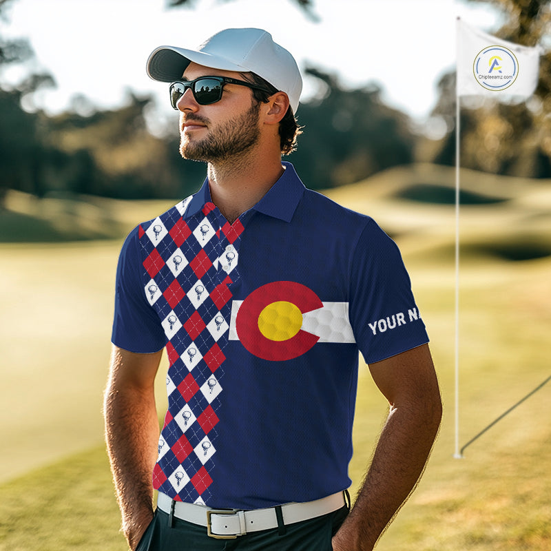 Male golfer wearing Colorado flag golf polo at scenic mountain golf course, perfect for golf vacations, outdoor adventure and state pride.